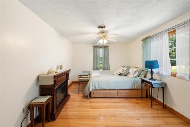 472 Potter Rd, Framingham, MA 01701 - bedroom featuring light wood-style flooring, a textured ceiling, and ceiling fan