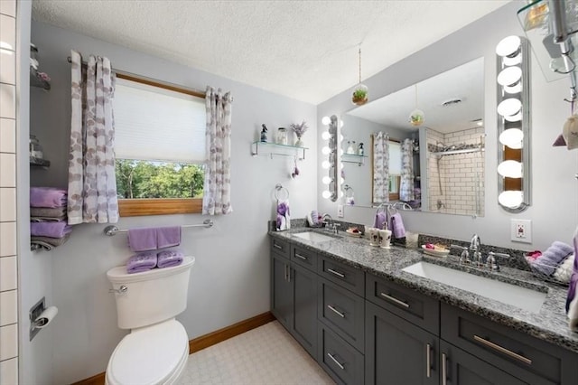 472 Potter Rd, Framingham, MA 01701 - full bath featuring double vanity, a textured ceiling, and a tile shower