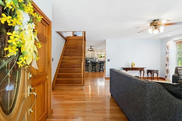 472 Potter Rd, Framingham, MA 01701 - living room featuring stairway, light wood-type flooring, and a ceiling fan