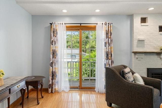 472 Potter Rd, Framingham, MA 01701 - entryway with wood finished floors, a brick fireplace, and recessed lighting