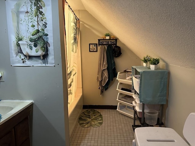 89-91 Cambridge St, Lawrence, MA 01843 - bathroom with lofted ceiling, a textured ceiling, vanity, and tile patterned floors