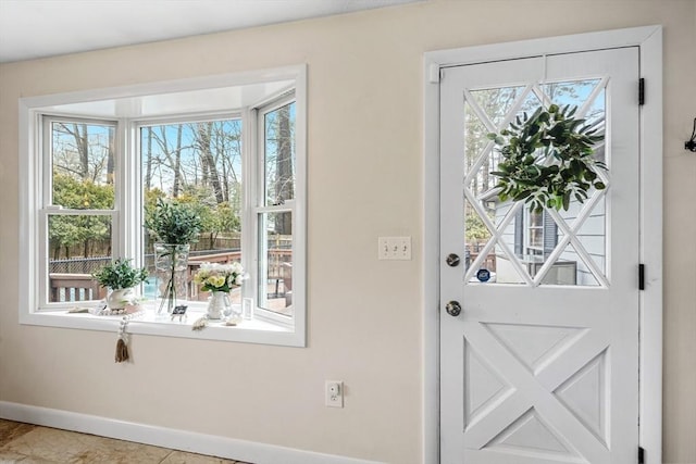 doorway to outside with baseboards