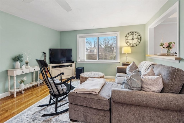 living area with wood finished floors and baseboards