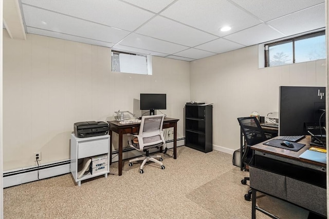 carpeted office featuring plenty of natural light, a paneled ceiling, and baseboard heating