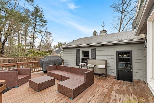 deck with area for grilling, an outdoor living space, and fence