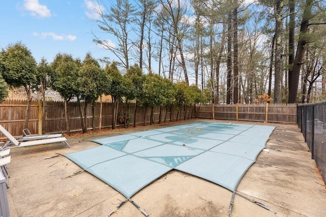 view of swimming pool featuring a patio area, a fenced in pool, and a fenced backyard