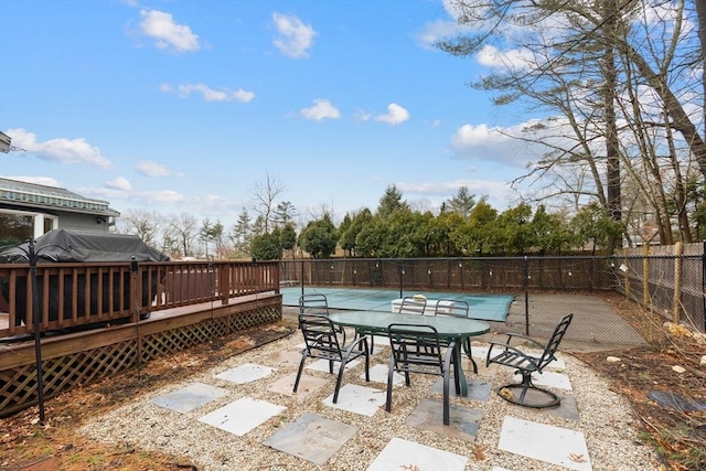 view of patio with fence, a fenced in pool, and a wooden deck