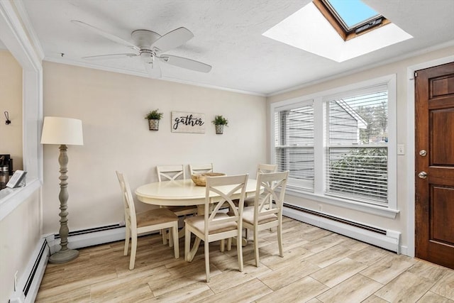 dining room with a baseboard heating unit, a ceiling fan, light wood-type flooring, and ornamental molding