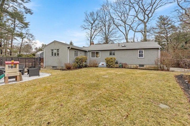 rear view of house with a patio area, a yard, and fence