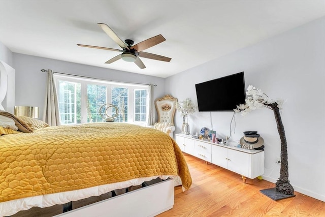 bedroom with ceiling fan and light hardwood / wood-style flooring