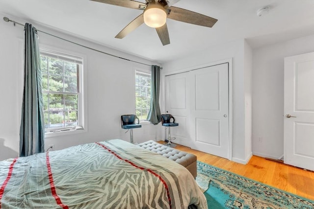 bedroom featuring a closet, hardwood / wood-style flooring, and ceiling fan