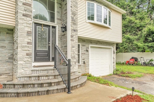 view of exterior entry with a garage