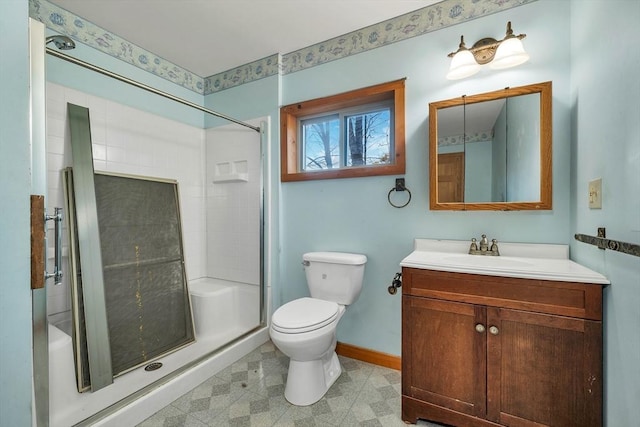 bathroom featuring vanity, toilet, and a shower