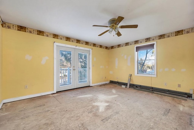 empty room featuring ceiling fan, baseboard heating, a wealth of natural light, and french doors