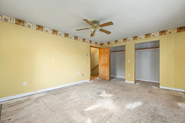 unfurnished bedroom with ceiling fan and multiple closets