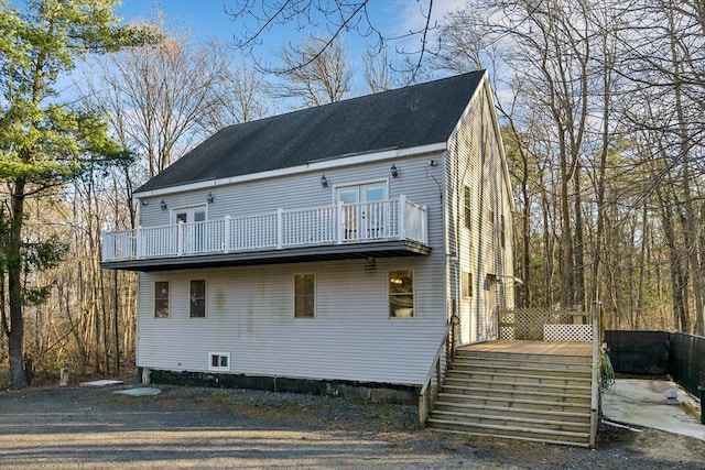 back of property with a balcony