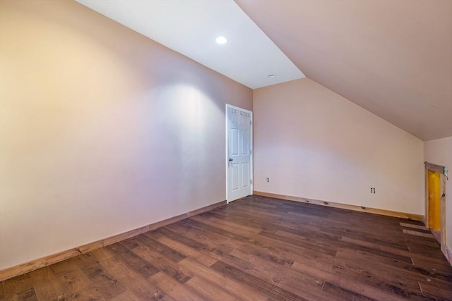 additional living space with dark hardwood / wood-style flooring and lofted ceiling