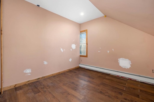 additional living space with baseboard heating, wood-type flooring, and lofted ceiling