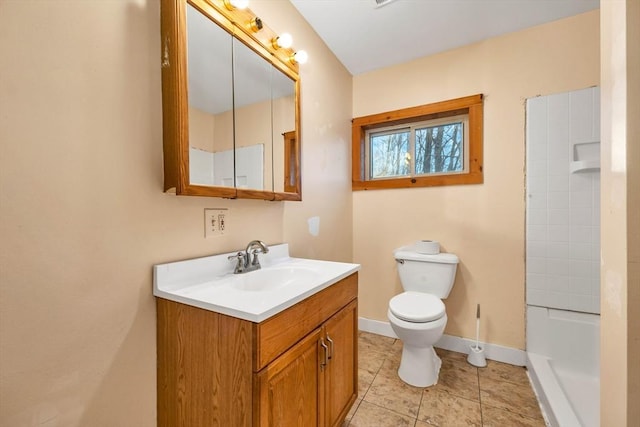 bathroom featuring tile patterned flooring, vanity, and toilet