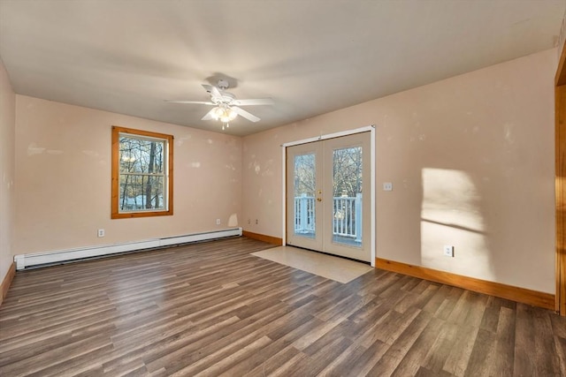 unfurnished room with french doors, plenty of natural light, a baseboard heating unit, and hardwood / wood-style floors