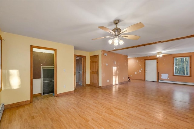 spare room with ceiling fan, light hardwood / wood-style floors, and a baseboard heating unit