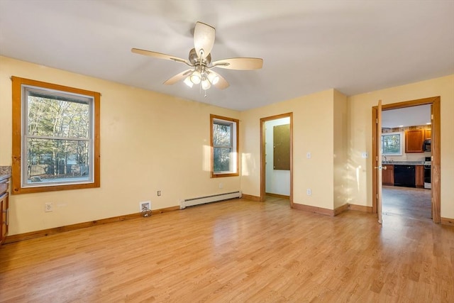 empty room featuring light hardwood / wood-style flooring, baseboard heating, and ceiling fan