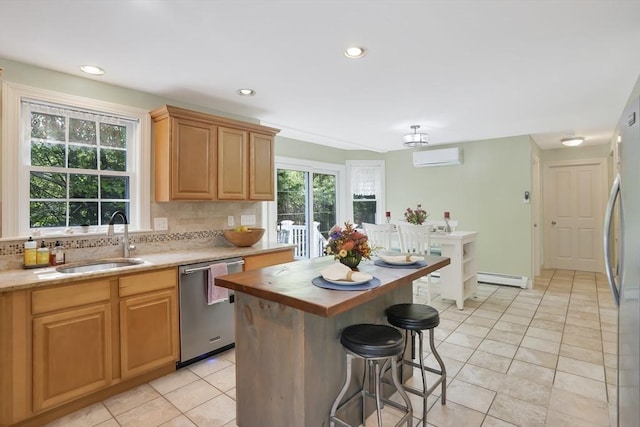 71 Sixth St N, Edgartown, MA 02539 - kitchen featuring stainless steel appliances, a sink, baseboard heating, tasteful backsplash, and light tile patterned floors