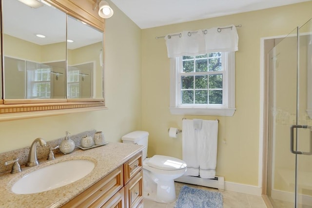 71 Sixth St N, Edgartown, MA 02539 - bathroom featuring a baseboard radiator, a shower stall, toilet, vanity, and tile patterned flooring