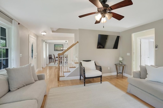 71 Sixth St N, Edgartown, MA 02539 - living room with wood finished floors, a chandelier, stairs, baseboards, and ceiling fan