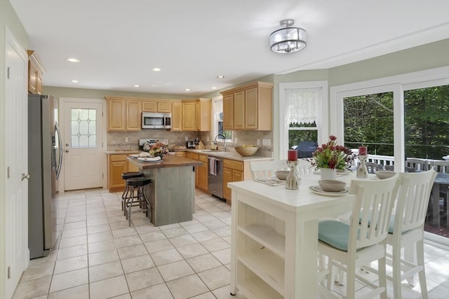 71 Sixth St N, Edgartown, MA 02539 - kitchen with appliances with stainless steel finishes, plenty of natural light, a breakfast bar area, backsplash, and recessed lighting