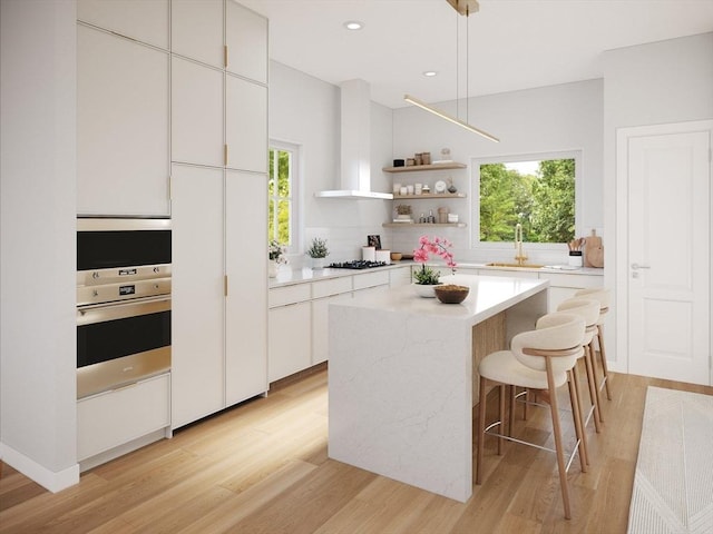 8 Elm St Unit 8, Newton, MA 02465 - kitchen with stainless steel oven, light wood finished floors, a sink, white cabinets, and recessed lighting