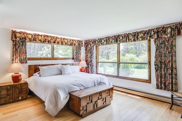 72 Highland Rd, Truro, MA 02666 - bedroom featuring multiple windows, a baseboard heating unit, and light wood finished floors