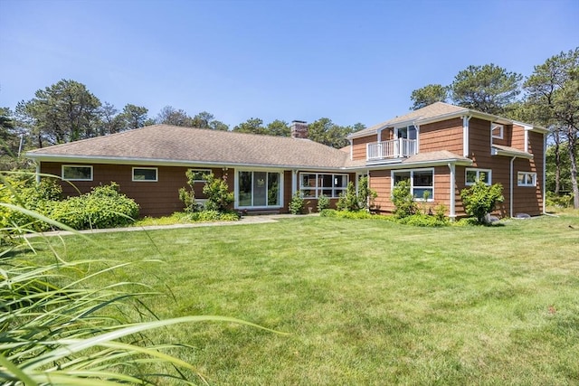 72 Highland Rd, Truro, MA 02666 - view of front facade featuring a chimney, a balcony, and a front yard