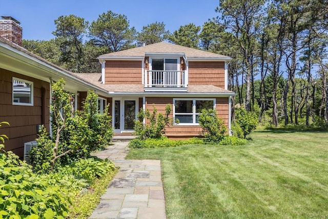 72 Highland Rd, Truro, MA 02666 - view of front of house with a balcony, roof with shingles, and a front lawn