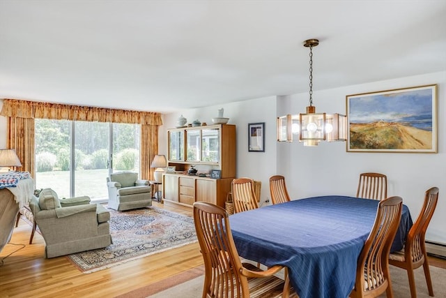 72 Highland Rd, Truro, MA 02666 - dining area featuring light wood-style flooring and a chandelier