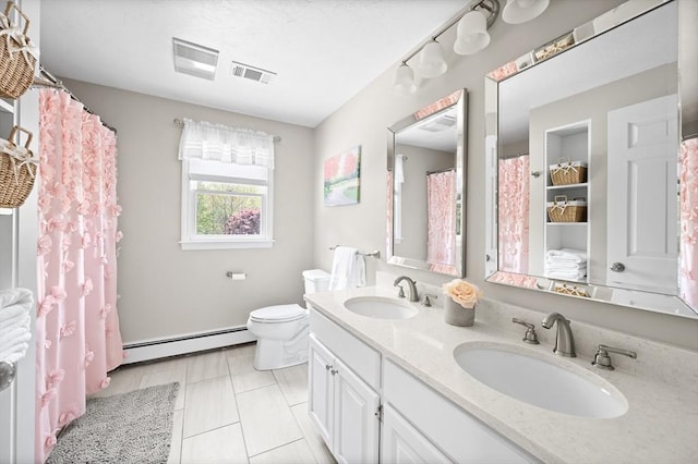 full bathroom featuring a sink, double vanity, toilet, and a baseboard heating unit