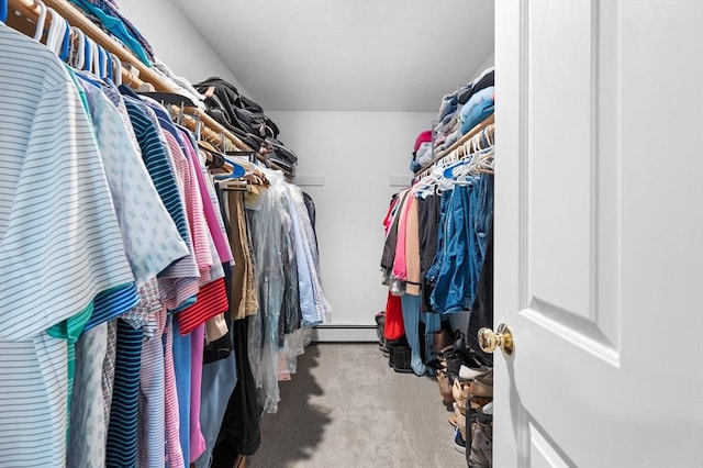 walk in closet with a baseboard heating unit and carpet floors