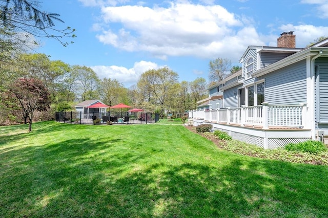 view of yard with fence and a wooden deck