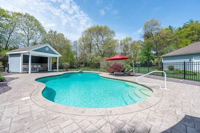 view of pool with a patio, fence, an outbuilding, and a fenced in pool