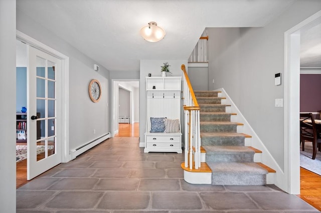stairway with baseboards, french doors, baseboard heating, and a baseboard heating unit