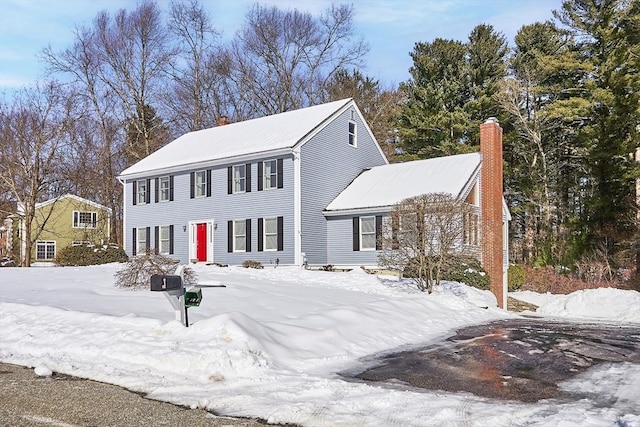 colonial home featuring a chimney