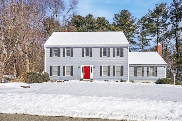 colonial home featuring a chimney