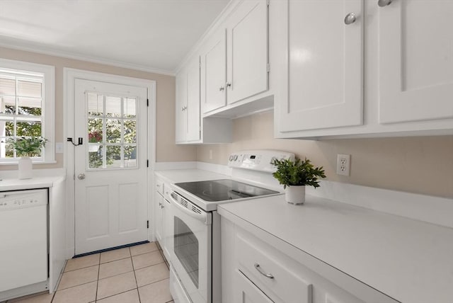 laundry room with laundry area, ornamental molding, and light tile patterned floors