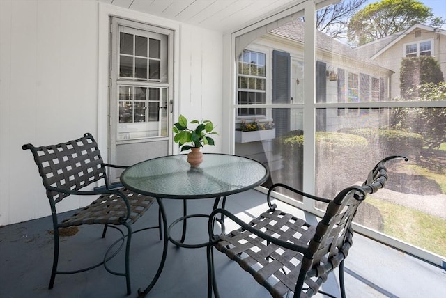 sunroom / solarium with outdoor dining area