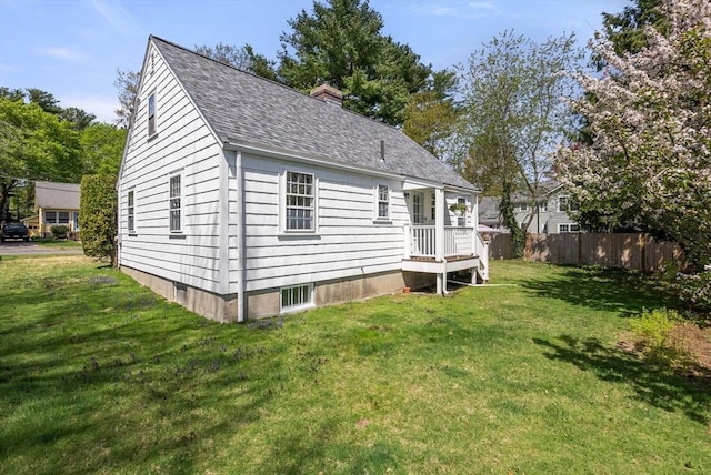 view of property exterior with a yard, fence, a chimney, and a shingled roof