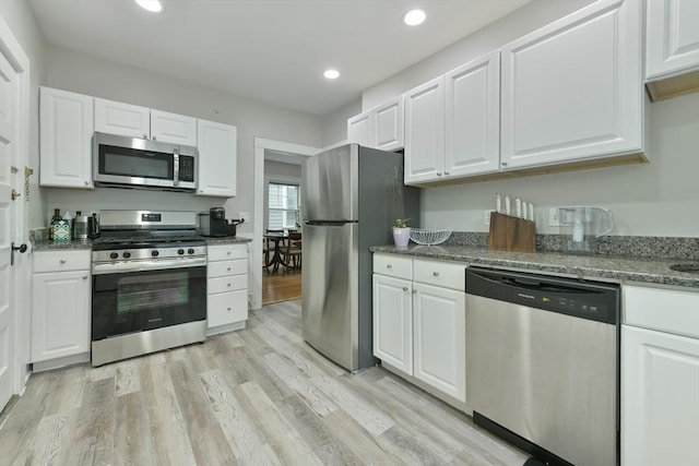 6 Brewer St Unit 2, Cambridge, MA 02138 - kitchen with stainless steel appliances, white cabinets, light wood-style flooring, and recessed lighting