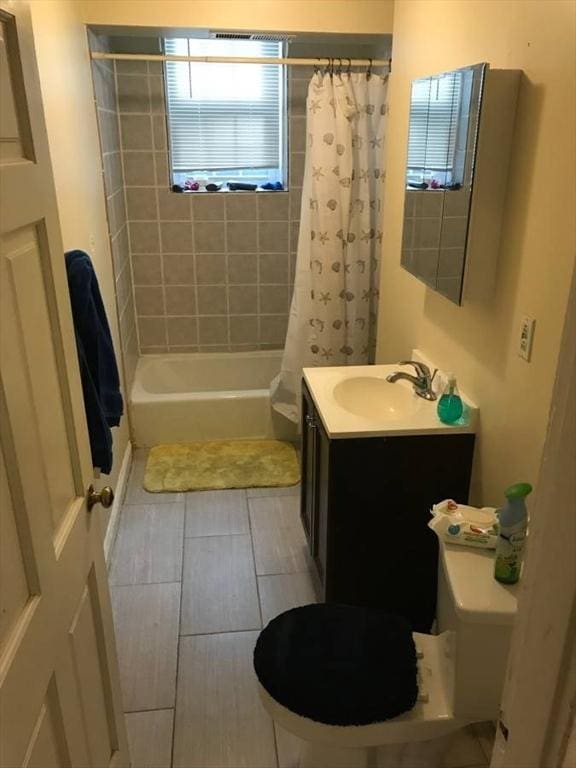 bathroom featuring shower / tub combo, vanity, and toilet