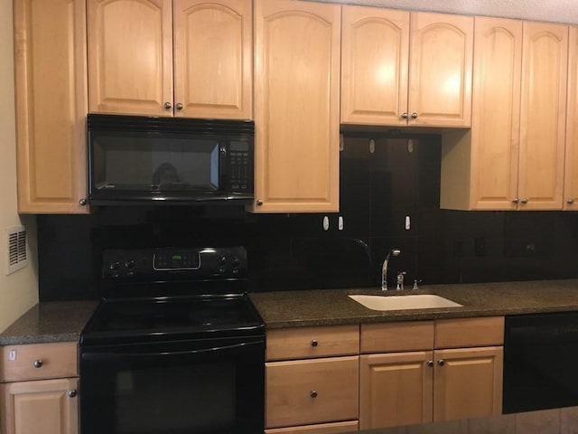 kitchen with black appliances, a sink, and backsplash