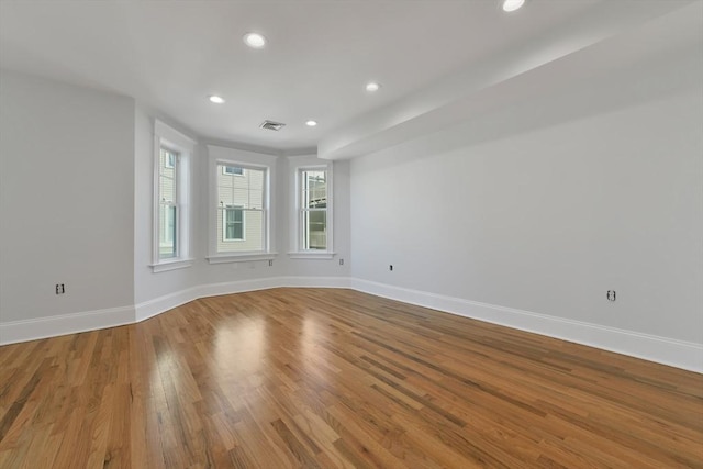 unfurnished room with hardwood / wood-style flooring