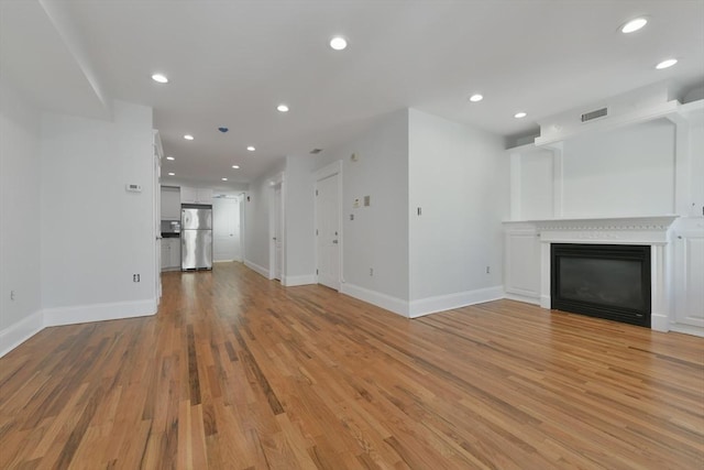 unfurnished living room featuring light hardwood / wood-style flooring